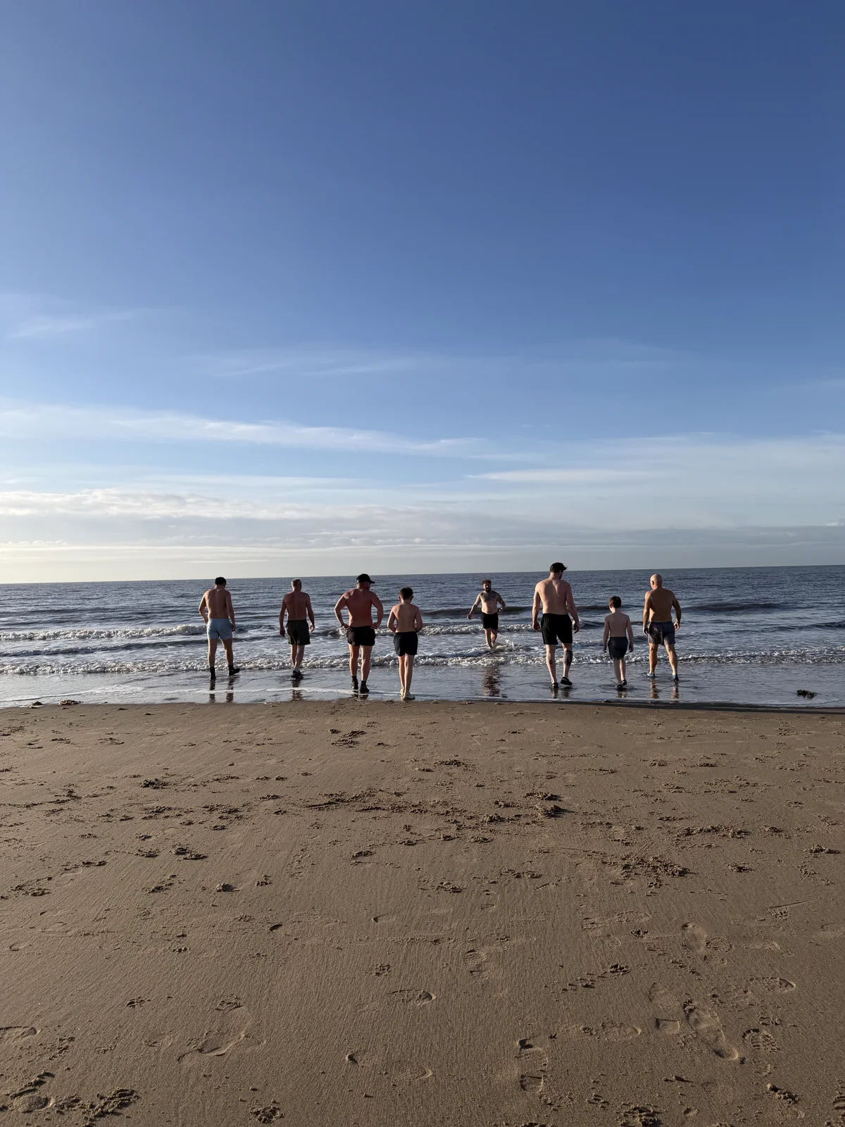 A Brotherhood group walking from the sand into the sea