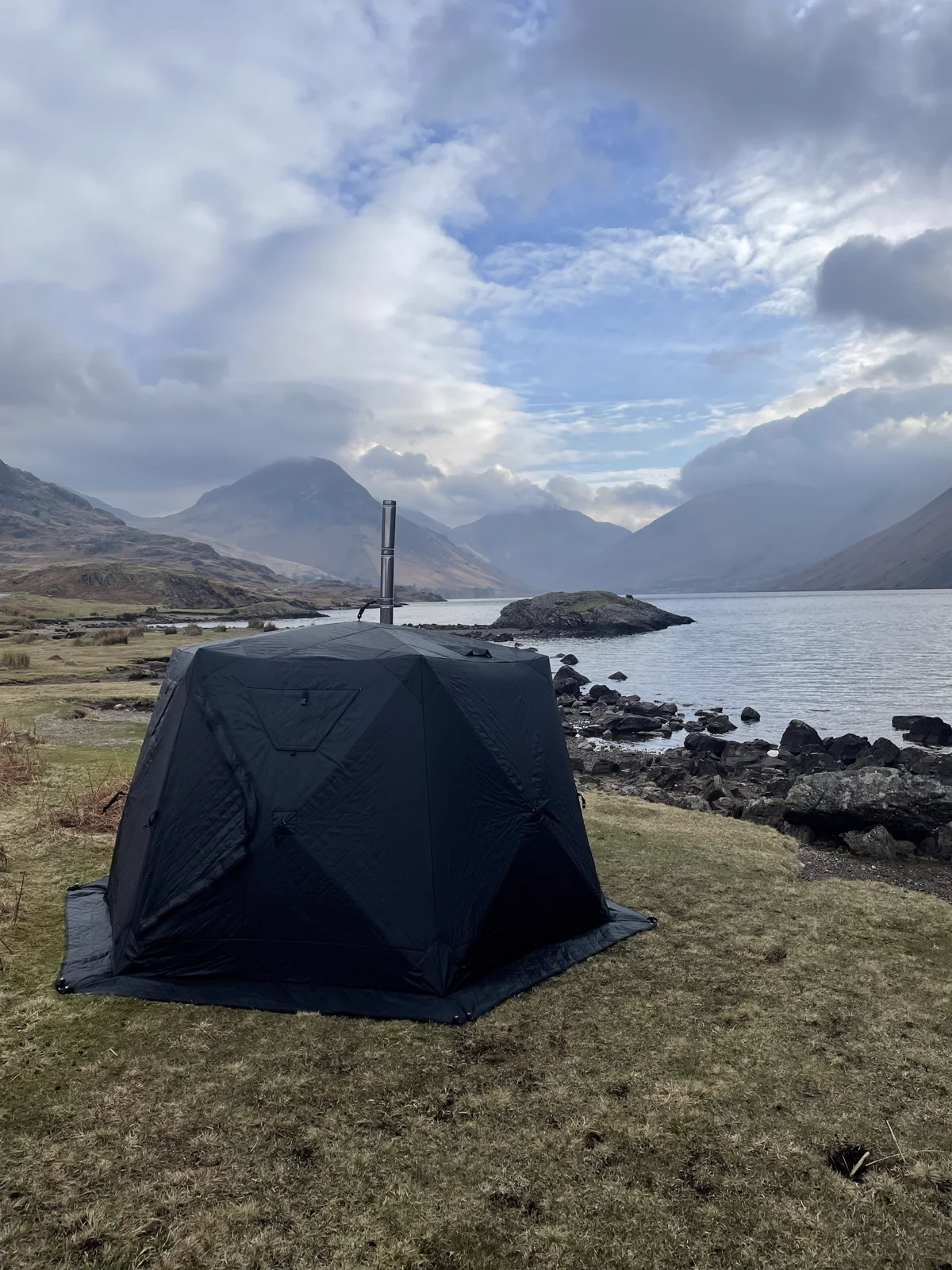 An outdoor sauna beside a mountain lake at a past Brotherhood event