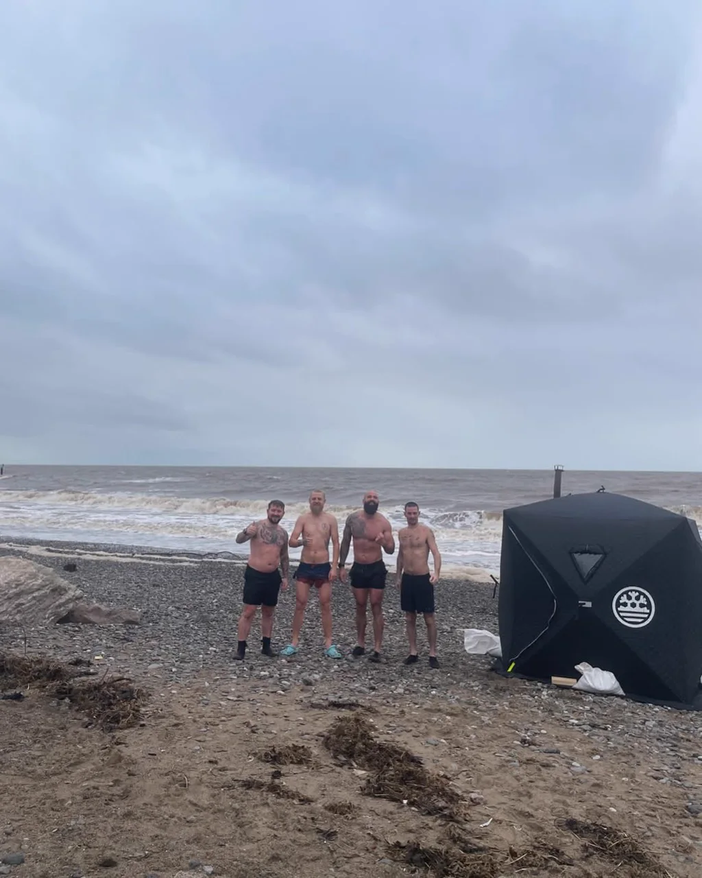 Four Brotherhood members with the sauna set up beside the sea